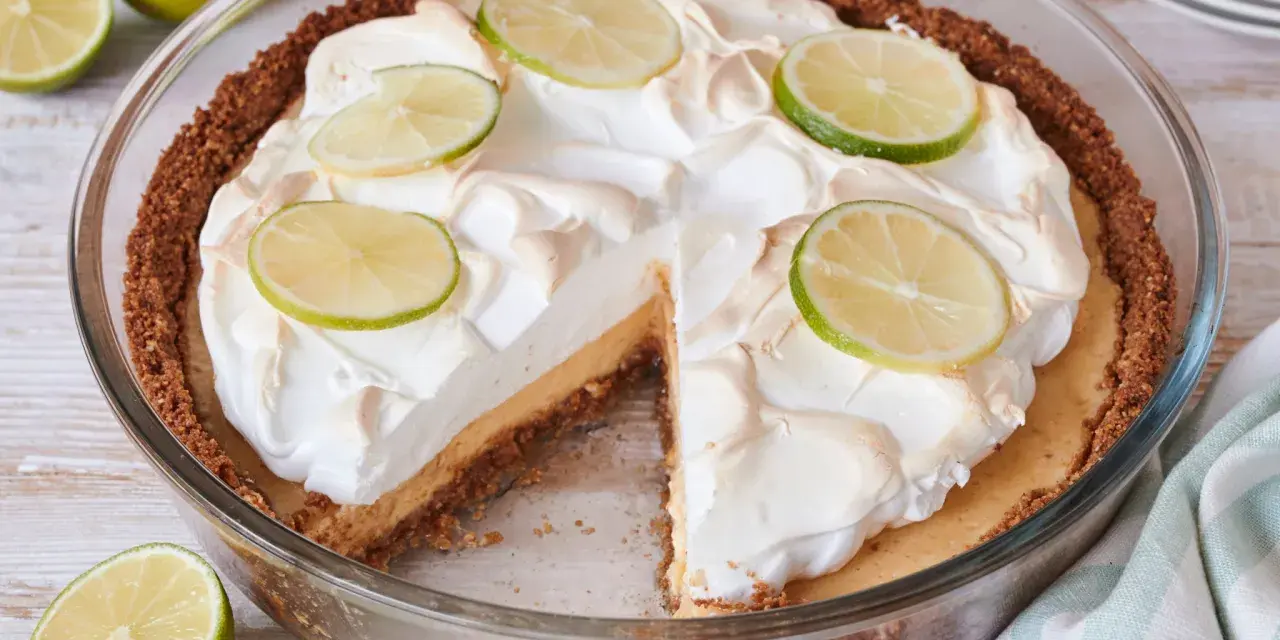 Ein köstlicher Key Lime Pie mit Baiserhaube und Limettenscheiben, bereit zum Genießen.