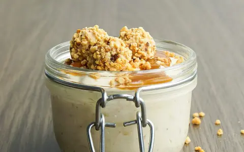 Cremiges Giotto Eis im Glas, garniert mit Karamell und gehackten Nüssen. Ein süßer Genuss!